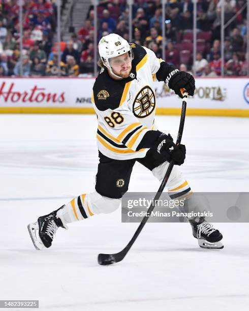 David Pastrnak of the Boston Bruins takes a shot during the first period against the Montreal Canadiens at Centre Bell on April 13, 2023 in Montreal,...