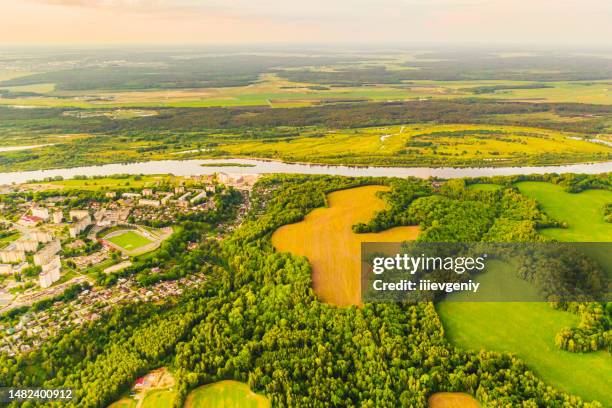 spring field aerial view. drone photography. sustainability. protection of nature. sunset sky background. green forest - fly casting stock pictures, royalty-free photos & images