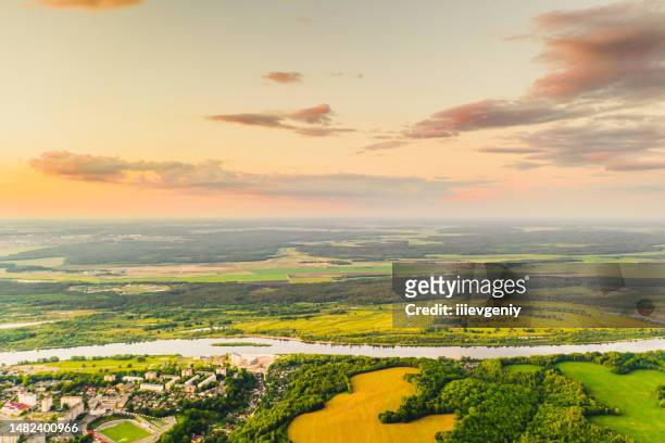 spring field aerial view. drone photography. sustainability. protection of nature. sunset sky background. green forest - carbon cycle stock pictures, royalty-free photos & images