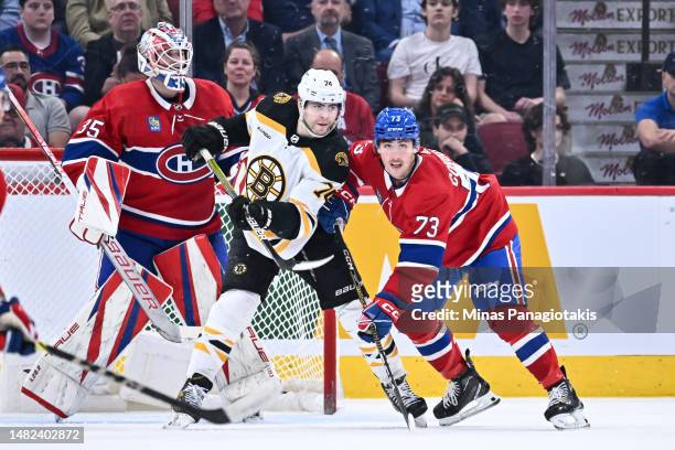 Jake DeBrusk of the Boston Bruins and Lucas Condotta of the Montreal Canadiens battle for position near goaltender Sam Montembeault during the second...