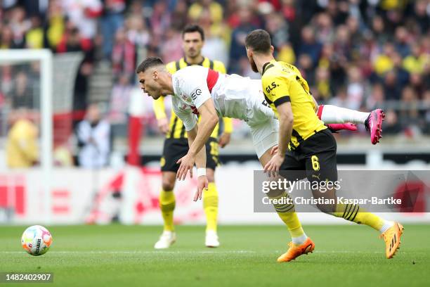 Konstantinos Mavropanos of VfB Stuttgart battles for possession with Salih Oezcan of Borussia Dortmund during the Bundesliga match between VfB...