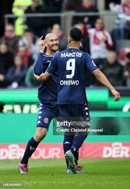 Ludovic Ajorque of 1.FSV Mainz 05 celebrates with teammate Karim Onisiwo after scoring the team's first goal during the Bundesliga match between 1....