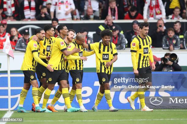 Donyell Malen of Borussia Dortmund celebrates with teammates after scoring the team's second goal during the Bundesliga match between VfB Stuttgart...