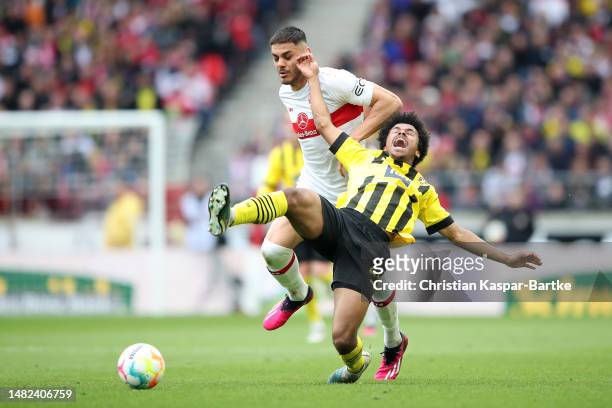 Donyell Malen of Borussia Dortmund is challenged by Konstantinos Mavropanos of VfB Stuttgart during the Bundesliga match between VfB Stuttgart and...