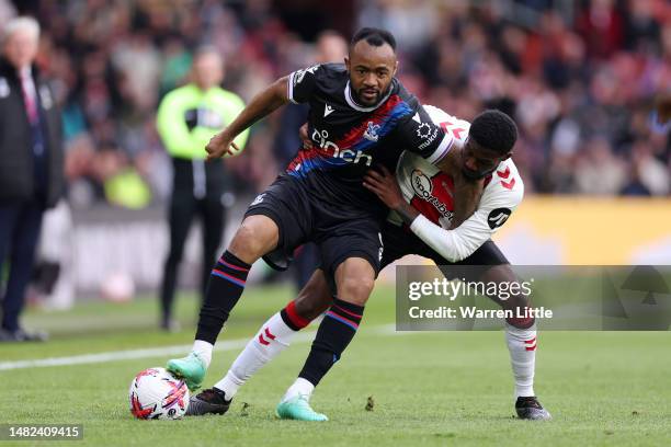 Jordan Ayew of Crystal Palace is challenged by Ainsley Maitland-Niles of Southampton during the Premier League match between Southampton FC and...