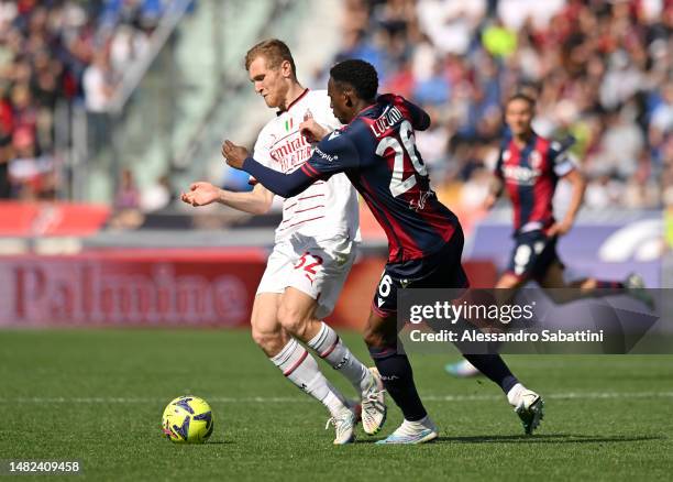 Tommaso Pobega of AC Milan and Jhon Lucumi of Bologna FC battle for the ball during the Serie A match between Bologna FC and AC Milan at Stadio...