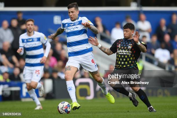 Lyndon Dykes of Queens Park Rangers vies for the ball with Gustavo Hamer of Coventry City during the Sky Bet Championship between Queens Park Rangers...