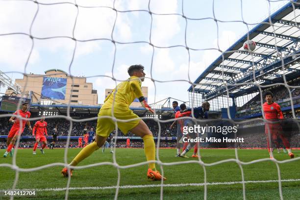 Danny Welbeck of Brighton & Hove Albion scores the team's first goal past Kepa Arrizabalaga of Chelsea during the Premier League match between...