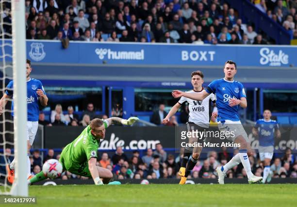 Daniel James of Fulham scores the team's third goal past Jordan Pickford of Everton during the Premier League match between Everton FC and Fulham FC...