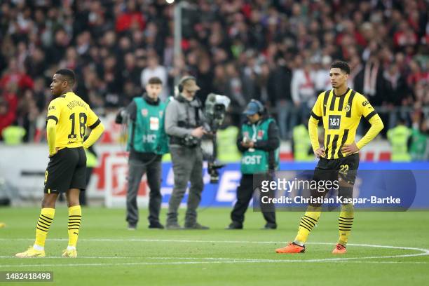 Youssoufa Moukoko and Jude Bellingham of Borussia Dortmund react after the team's draw in the Bundesliga match between VfB Stuttgart and Borussia...