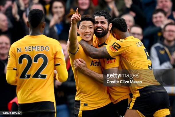 Hwang Hee-Chan of Wolverhampton Wanderers celebrates Diego Costa and Mario Lemina with teammates after scoring the team's second goal during the...
