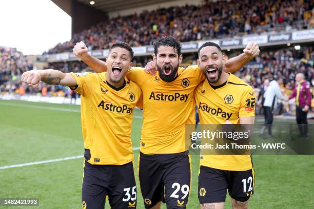 Joao Gomes, Diego Costa and Matheus Cunha of Wolverhampton Wanderers celebrate after the team's victory in the Premier League match between...