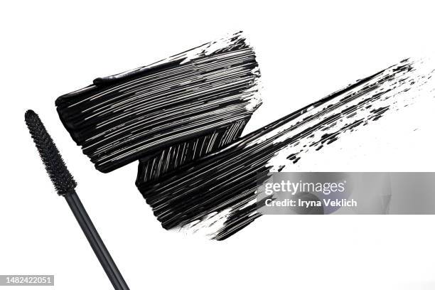 black smear mascara on white background, isolated. cosmetic make-up products for eyelashes. - farbprobe stock-fotos und bilder