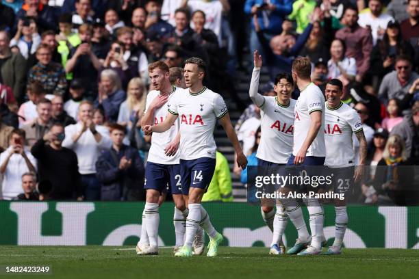 Son Heung-Min of Tottenham Hotspur celebrates with teammates after scoring the team's first goal during the Premier League match between Tottenham...