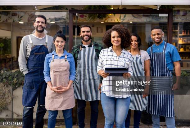 happy business owner with her staff at a coffee shop - small business owners stock pictures, royalty-free photos & images