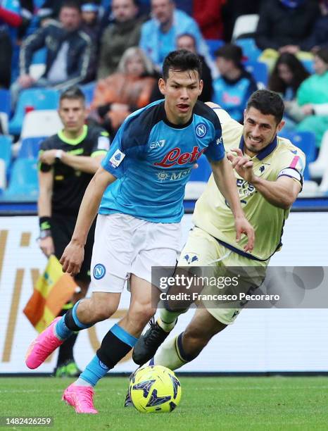 Hirving Lozano of SSC Napoli battles for possession with David Faraoni of Hellas Verona during the Serie A match between SSC Napoli and Hellas Verona...