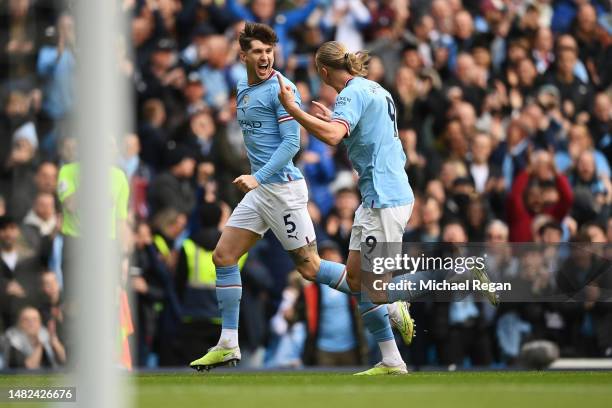 John Stones celebrates with Erling Haaland of Manchester City after scoring the team's first goal during the Premier League match between Manchester...
