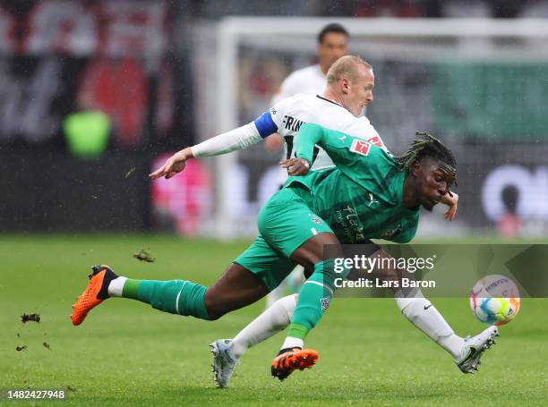 Sebastian Rode of Eintracht Frankfurt and Kouadio Kone of Borussia Moenchengladbach battle for the ball during the Bundesliga match between Eintracht...