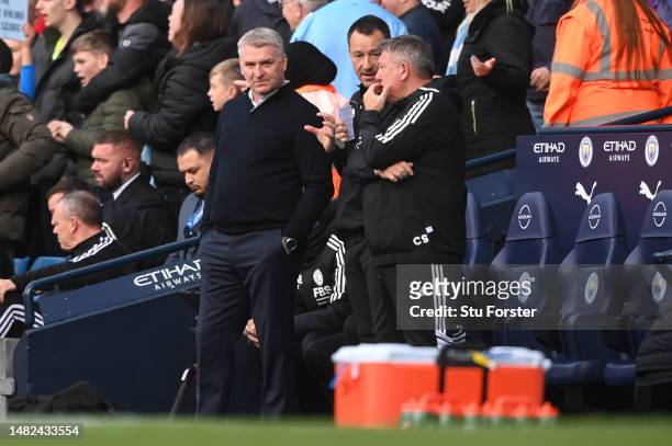 John Terry, Dean Smith and Craig Shakespeare, Assistant Manager of Leicester City, react during the Premier League match between Manchester City and...