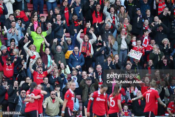Manchester United fans celebrate after Rachel Williams of Manchester United scores the team's third goal during the Vitality Women's FA Cup Semi...