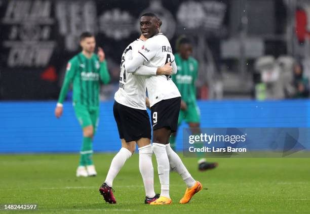 Randal Kolo Muani of Eintracht Frankfurt celebrates with teammate Lucas Alario after scoring the team's first goal during the Bundesliga match...