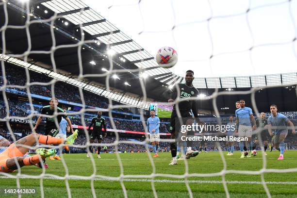 Kelechi Iheanacho of Leicester City scores the team's first goal during the Premier League match between Manchester City and Leicester City at Etihad...