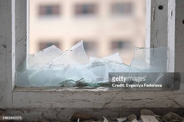 window of an apartment building with broken glass - pounce attack stock pictures, royalty-free photos & images