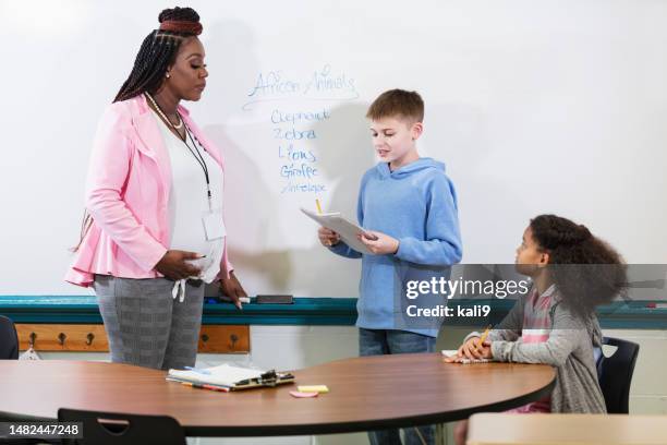 pregnant teacher in class teaching elementary students - boy in briefs stock pictures, royalty-free photos & images