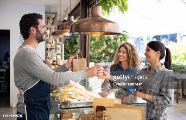 happy female friends buying take out food at a coffee shop - reusable cup stock pictures, royalty-free photos & images