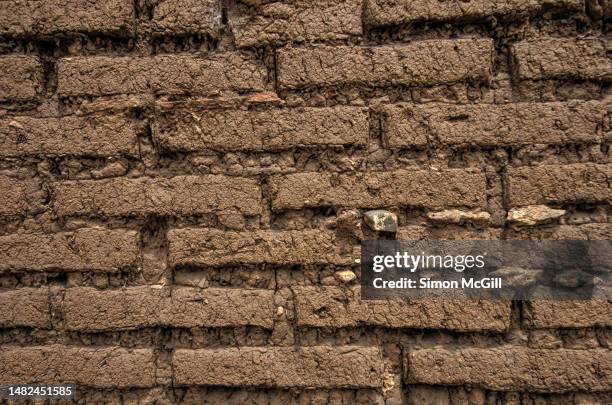 detail of an adobe mud brick wall - adobe wall fotografías e imágenes de stock