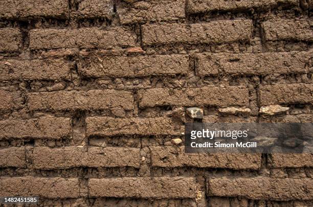 detail of an adobe mud brick wall - adobe texture stock pictures, royalty-free photos & images
