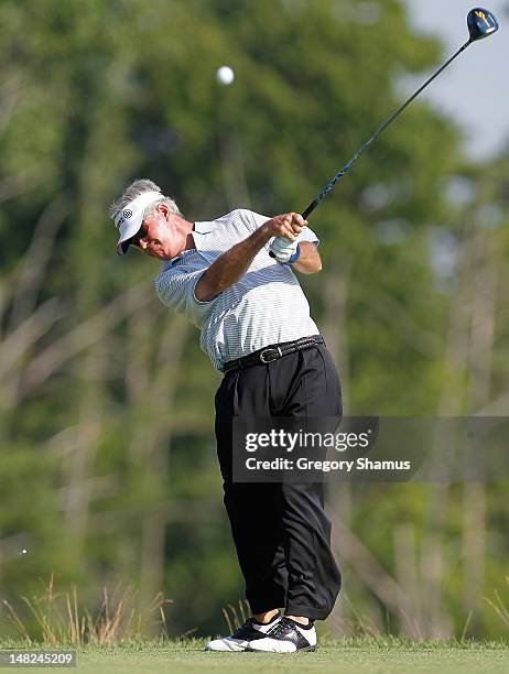 John Harris hits his tee shot on the ninth hole during the first round of the 2012 Senior United States Open at Indianwood Golf and Country Club on...