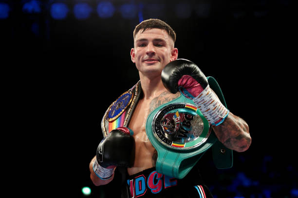 Sam Noakes celebrates victory while holding his Commonwealth and WBC International Silver Lightweight Title belts during the Commonwealth and WBC...