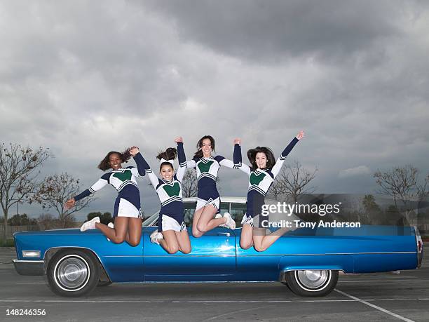 cheerleaders jumping by car - black cheerleaders fotografías e imágenes de stock