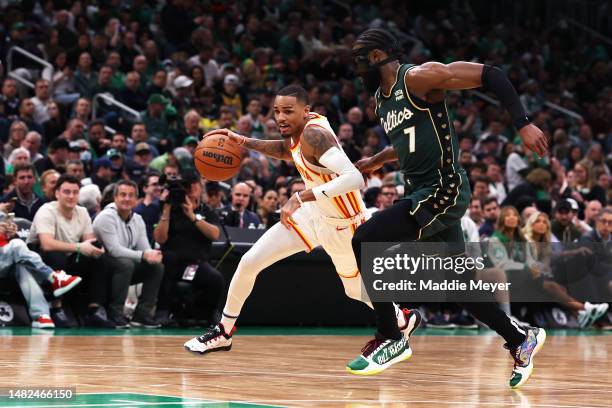 Dejounte Murray of the Atlanta Hawks drives down court against Jaylen Brown of the Boston Celtics during the second quarter of Game One of the...