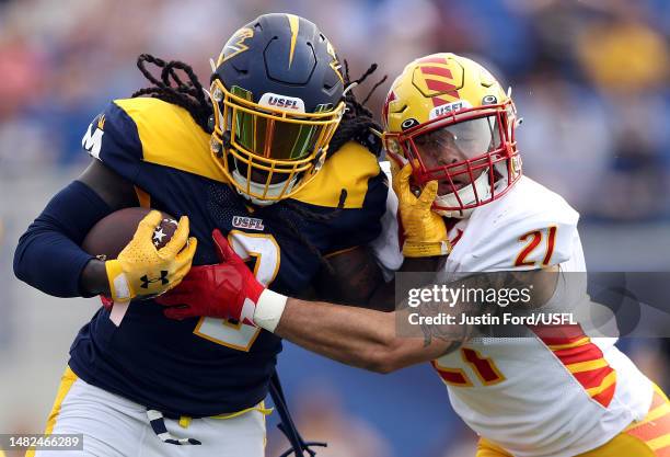 Running back Alex Collins of the Memphis Showboats carries the ball as safety Cody Brown pf the Philadelphia Stars defends during the 1st quarter of...