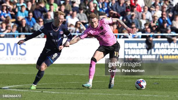 Mitch Pinnock of Northampton Town attempts to move forward with the ball under pressure from Callum Guy of Carlisle United during the Sky Bet League...