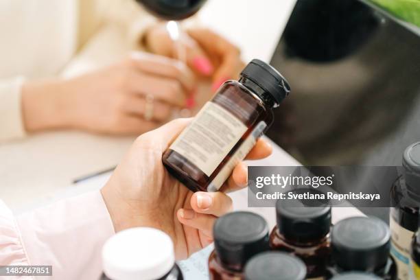 female dietitian consults a client on taking medications and vitamins - antioxidant stock pictures, royalty-free photos & images
