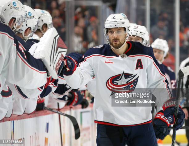 Sean Kuraly of the Columbus Blue Jackets celebrates his third period power-play goal against the Philadelphia Flyers with his teammates on the bench...
