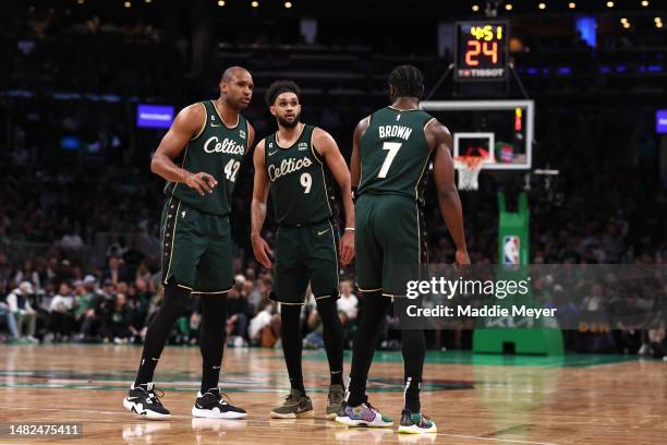 Al Horford, Derrick White and Jaylen Brown of the Boston Celtics talk during the second quarter of Game One of the Eastern Conference First Round...