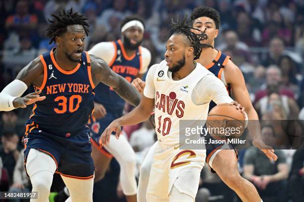 Julius Randle of the New York Knicks guards Darius Garland of the Cleveland Cavaliers during the first quarter of Game One of the Eastern Conference...