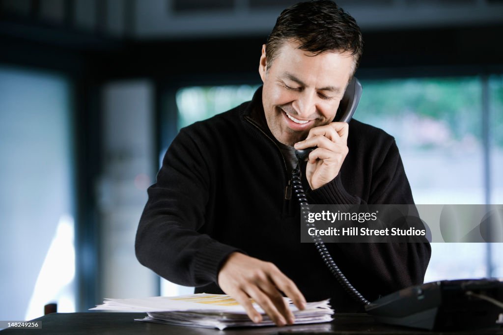 Hispanic businessman talking on telephone