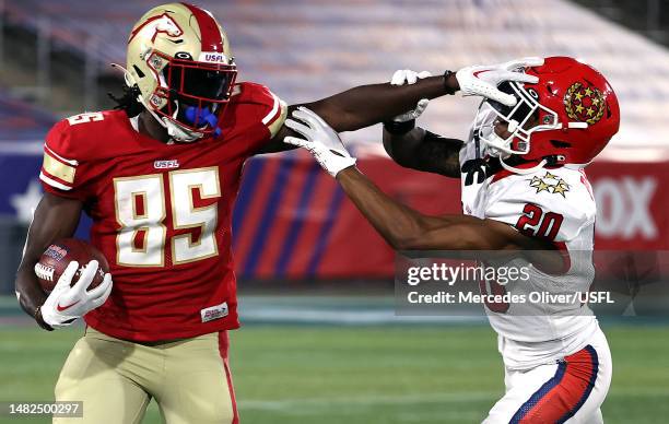 Wide receiver Deon Cain of the Birmingham Stallions stiff-arms cornerback DJ Daniel of the New Jersey Generals on a punt return during the game at...