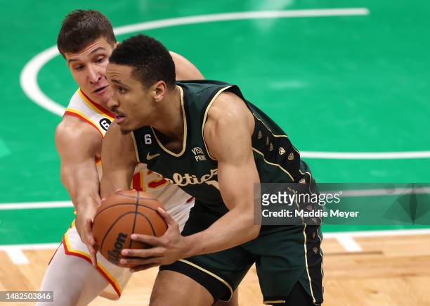 Bogdan Bogdanovic of the Atlanta Hawks defends Malcolm Brogdon of the Boston Celtics during the second half of Game One of the Eastern Conference...