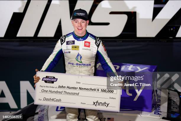 John Hunter Nemechek, driver of the Pye Barker Fire & Safety Toyota, poses with the $100,000 Xfinity Dash 4 Cash check in victory lane after winning...