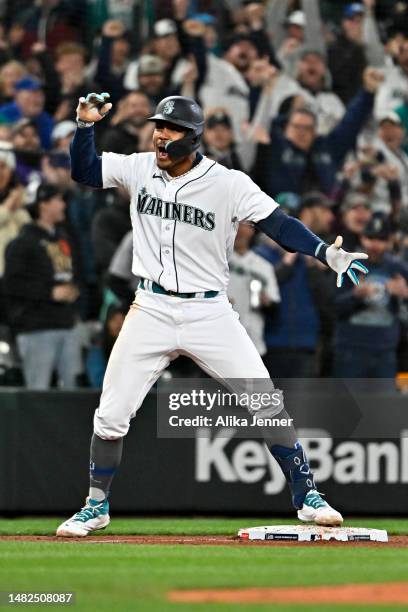 Julio Rodriguez of the Seattle Mariners celebrates after hitting a triple during the fourth inning of the game against the Colorado Rockies at...