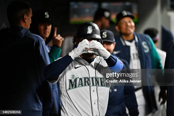 Eugenio Suarez of the Seattle Mariners gestures after hitting a home run during the fourth inning of the game against the Colorado Rockies at...