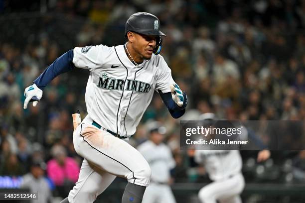 Julio Rodriguez of the Seattle Mariners runs to first base while Jarred Kelenic runs home during the sixth inning of the game against the Colorado...