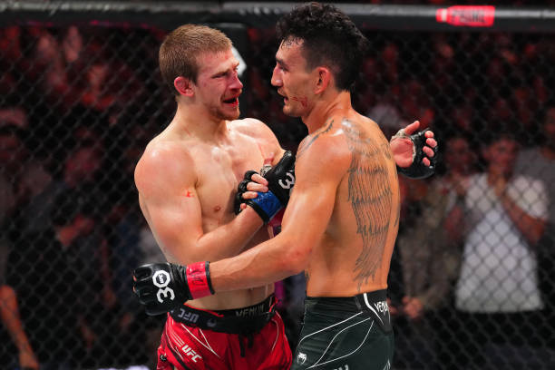 Arnold Allen of England and Max Holloway embrace after finishing five rounds in a featherweight fight during the UFC Fight Night event at T-Mobile...