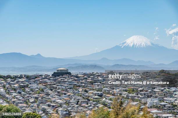 snowcapped mt. fuji and the residential district by the sea in kanagawa of japan - kamakura stock pictures, royalty-free photos & images